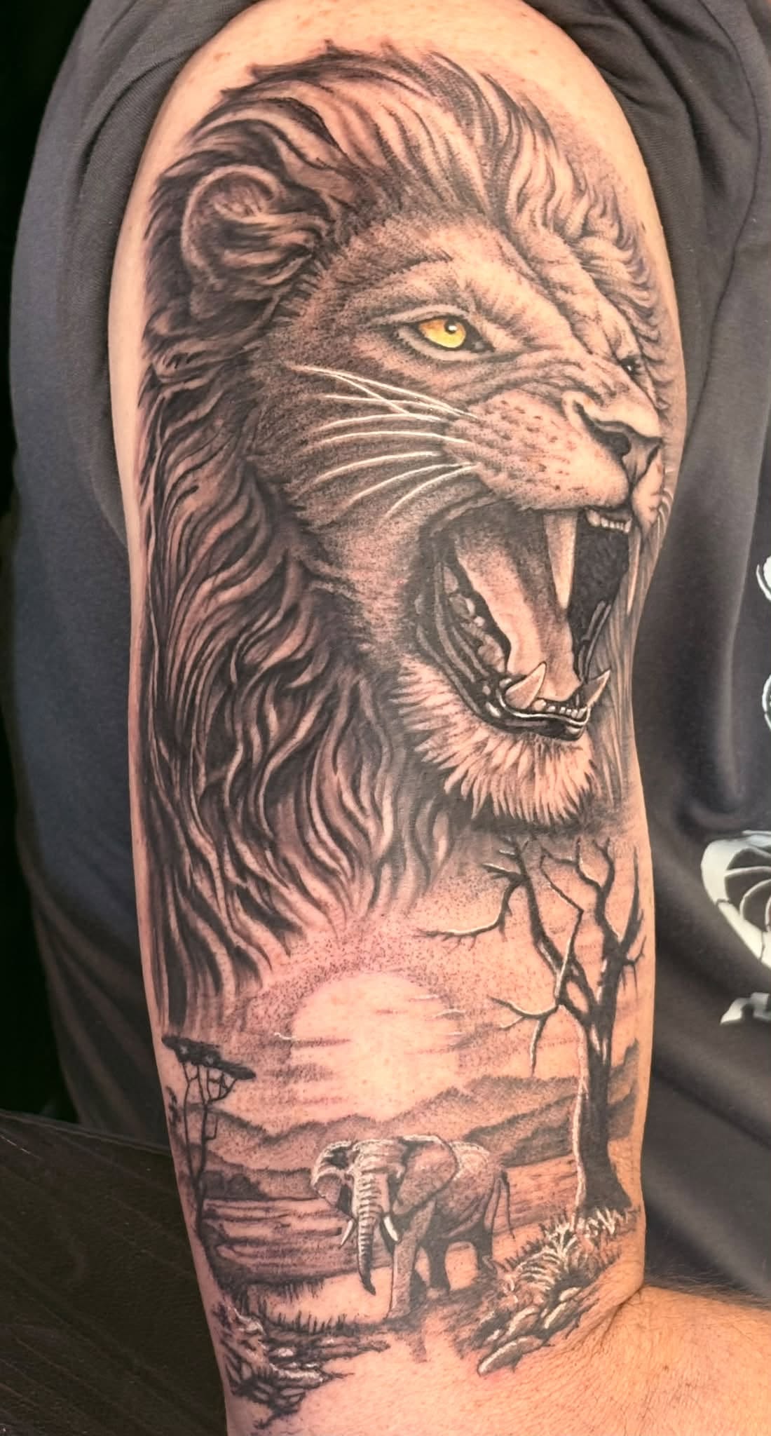 Detailed lion tattoo by Lomax Tattoo Studio